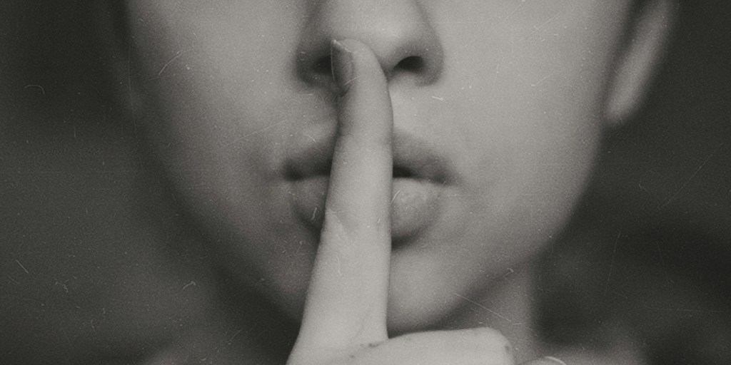 Finger over lips